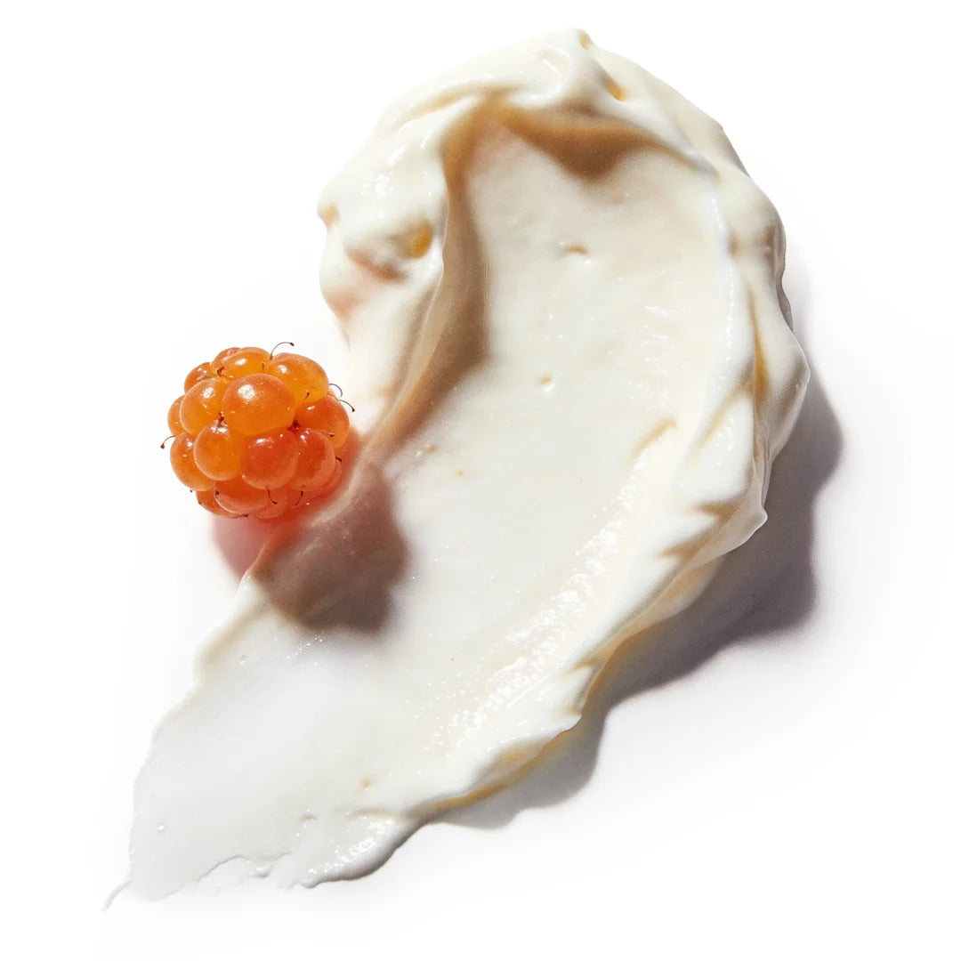 Top view of a smooth nourishing cream texture with a soft, rich surface and a single cloudberry on a bright white background, representing hydrating and antioxidant skincare ingredients