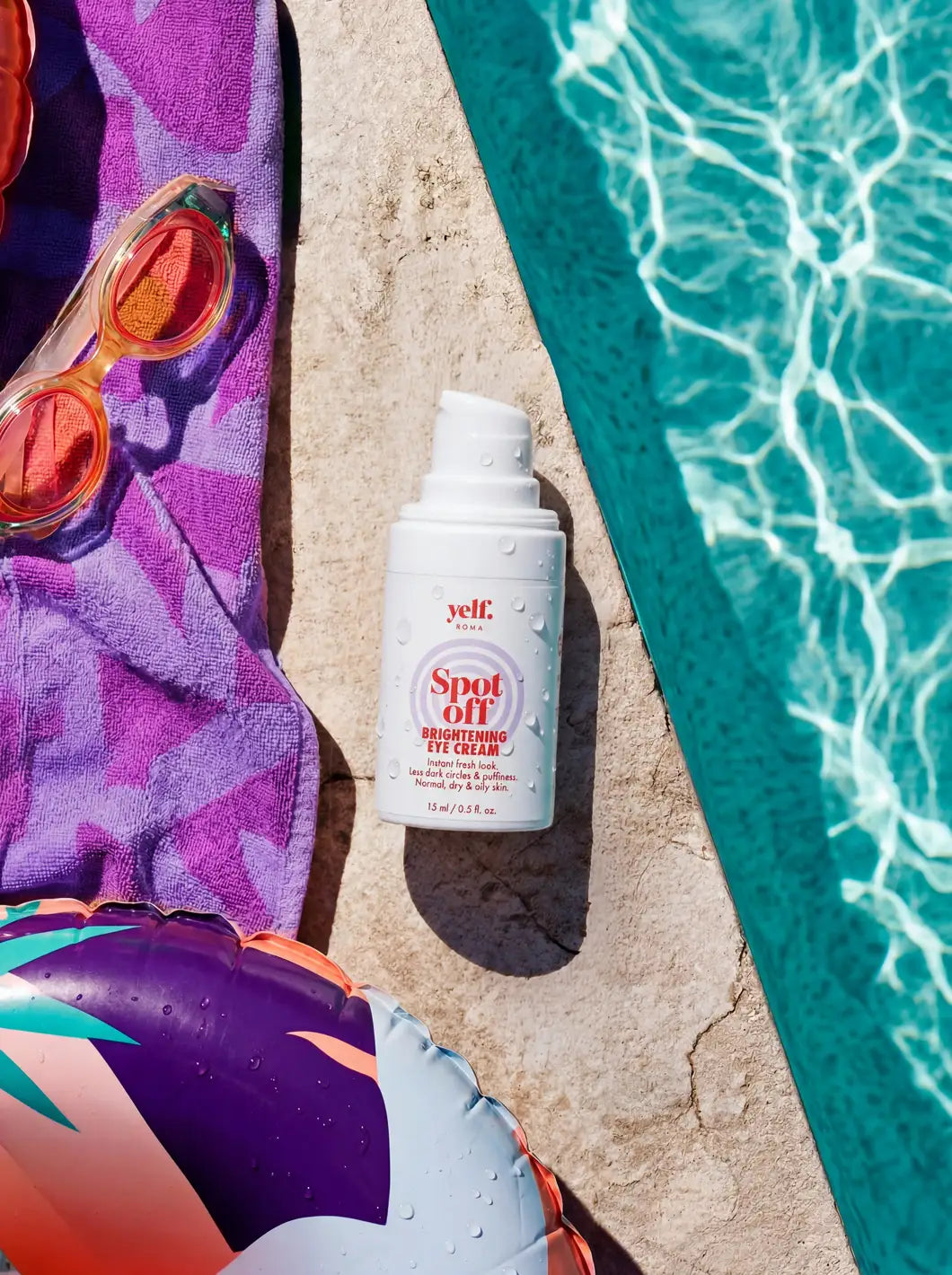 Yelf Spot Off Brightening Eye Cream on a sunlit pool edge with towel, goggles and water reflections in a vibrant summer scene