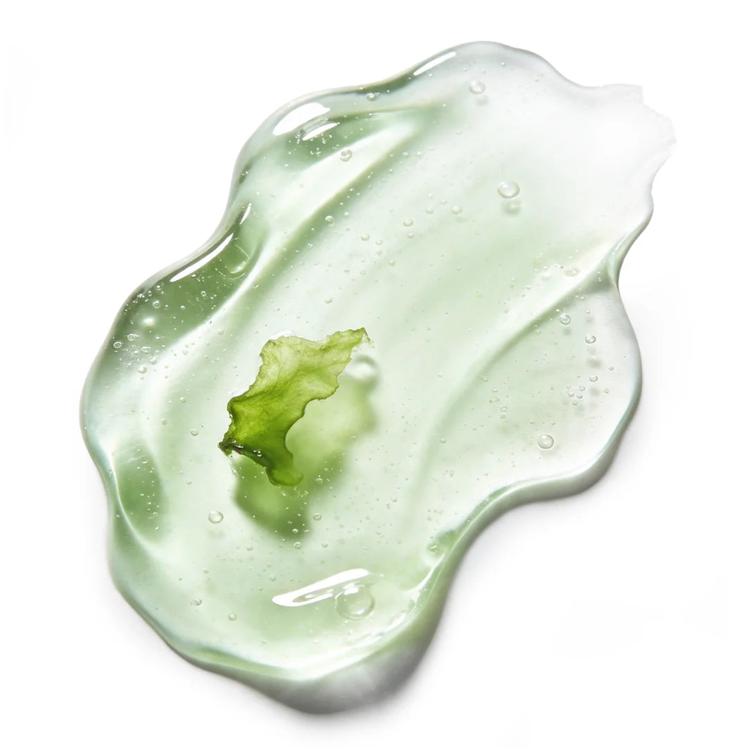Yelf Viva el Boost Caffeine Gel shown as a glossy green gel with a natural leaf element and fine bubbles, bright studio lighting, minimal skincare aesthetic